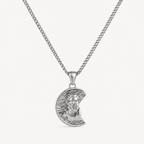 A silver pendant necklace featuring a crescent moon with a detailed portrait of Jesus Christ, suspended from a classic curb chain against a clean white background.