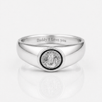 A polished silver signet ring engraved with 'Daddy I Love you' on the inside band, featuring a circular medallion with a silver statue of Lord Ganesha in the center, set against a clean white background with a soft reflection.