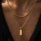 Man Wearing a gold chain and pendant in the sun with an open neck top