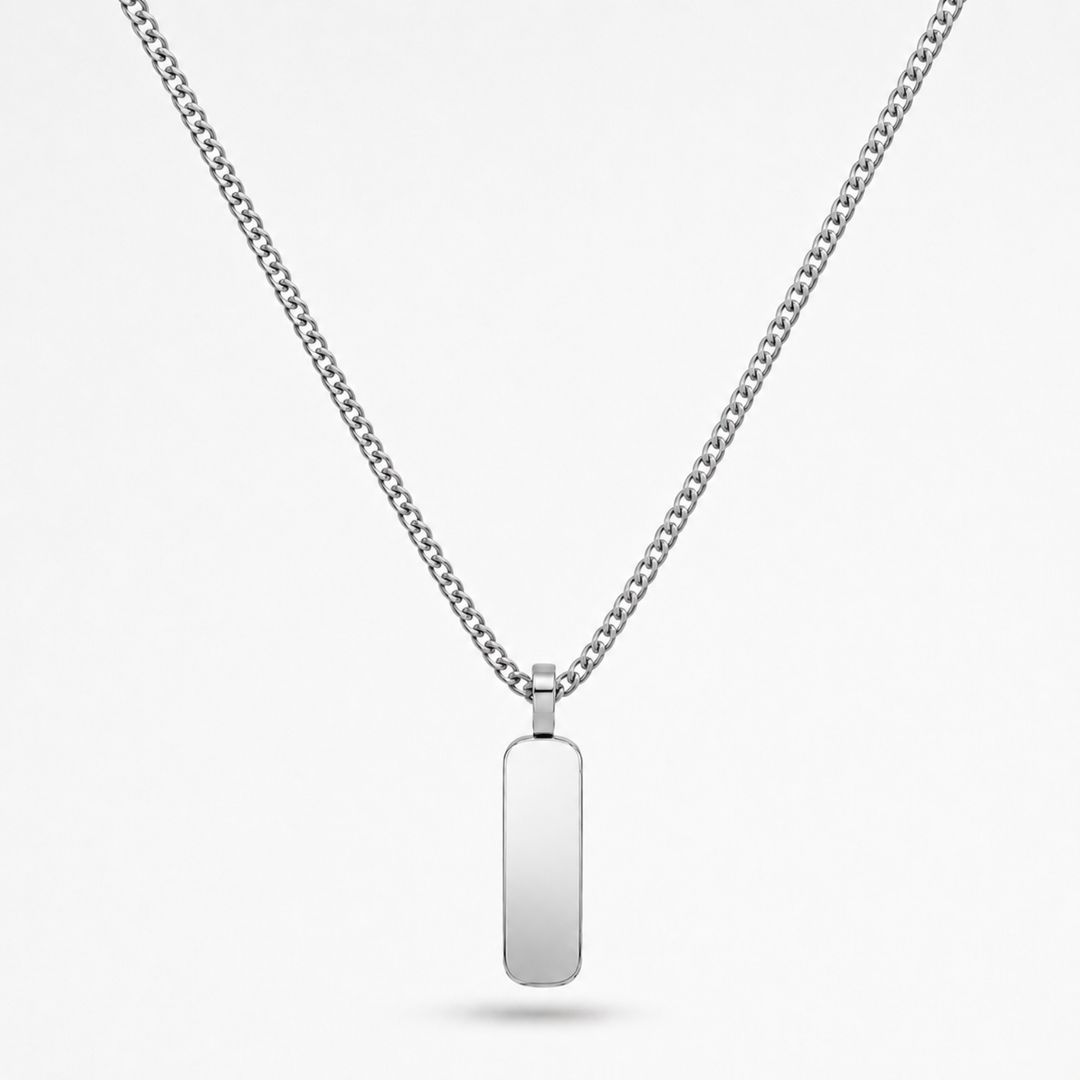 A silver-toned stainless steel chain necklace with a flat, polished rectangular dog tag pendant, shown against a light gray background.