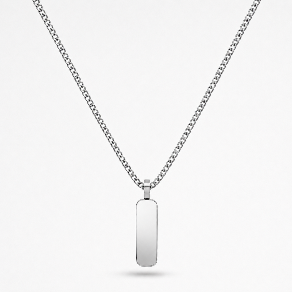 A silver-toned stainless steel chain necklace with a flat, polished rectangular dog tag pendant, shown against a light gray background.