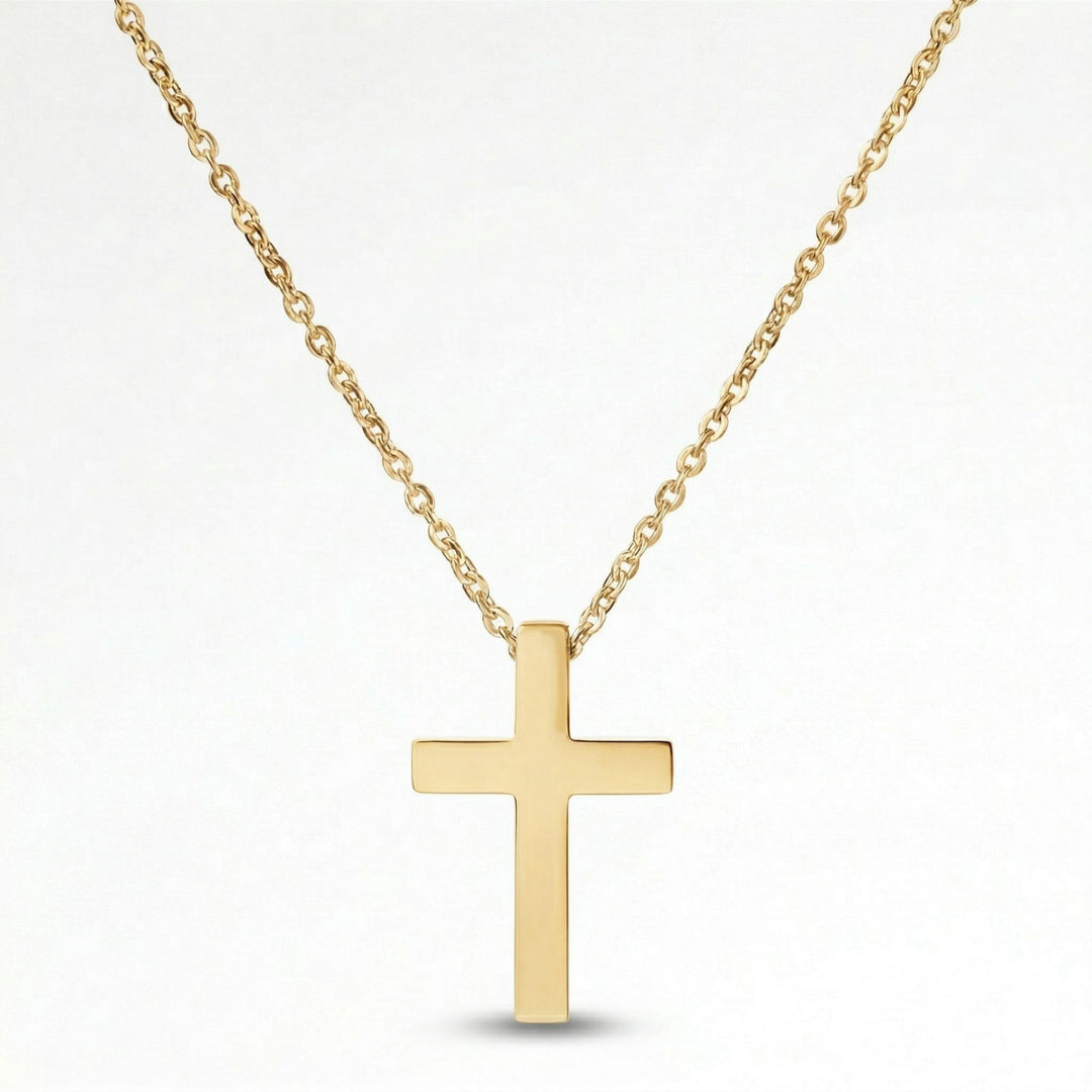 A gold cross pendant necklace against a white background.