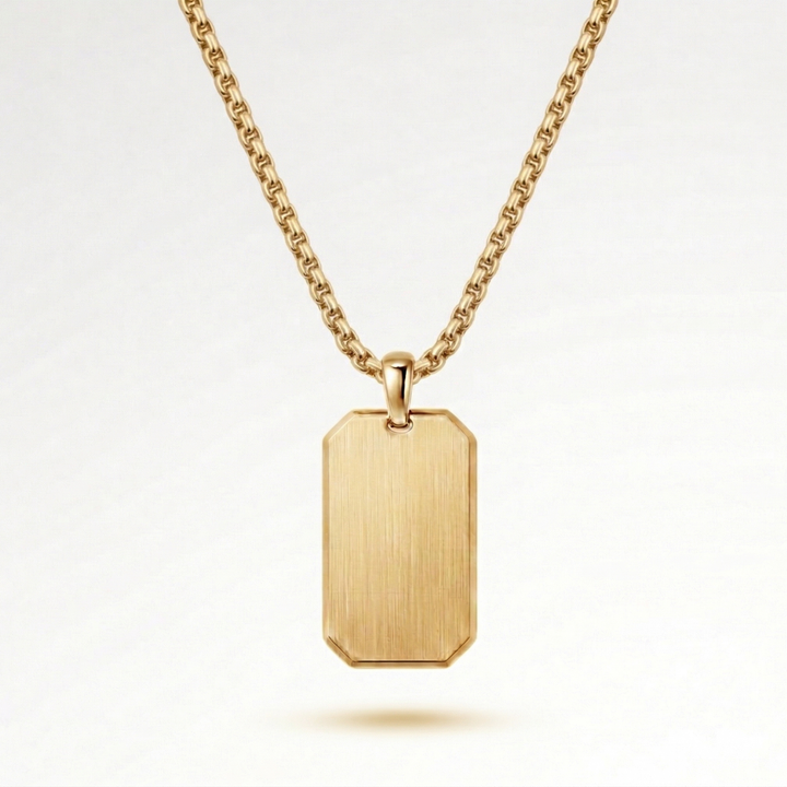 A gold-colored necklace with a rectangular pendant hanging from a chain.