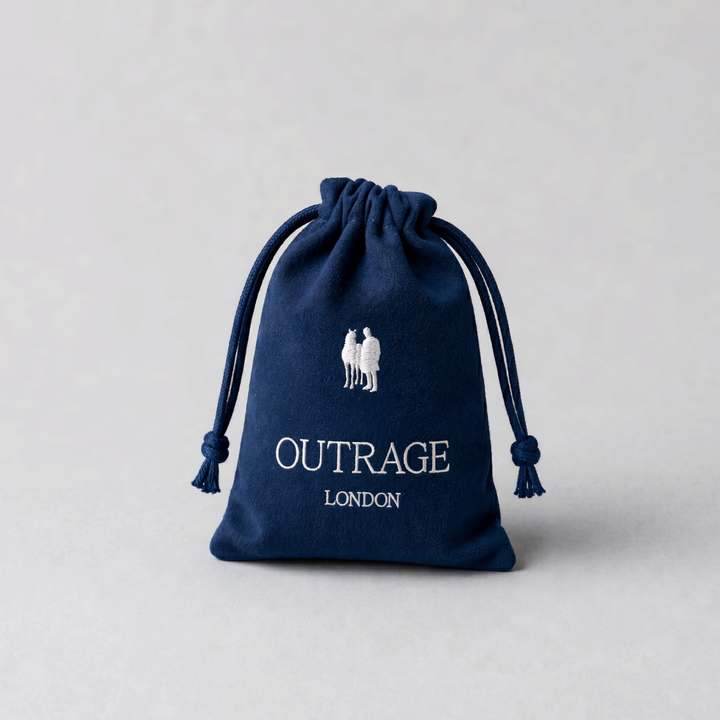 Navy blue drawstring bag with 'Outrage London' branding on a light gray background